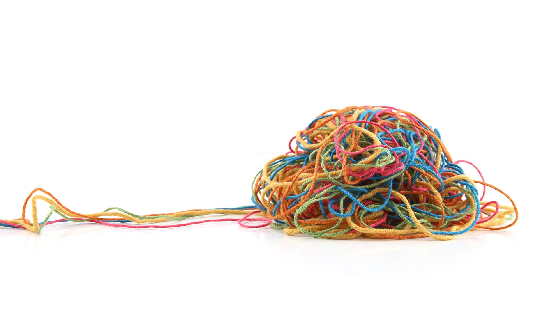 Tangled colorful cotton threads isolated on white background.